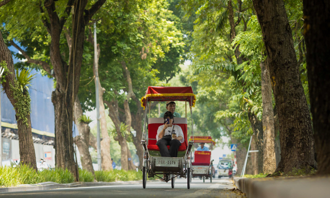 A tourist takes a cyclo ride on a street in Hanoi, 2022. Photo by Vu Ngoc Thien